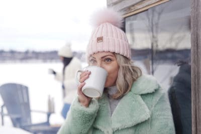 Girl sipping hot chocolate during winter.